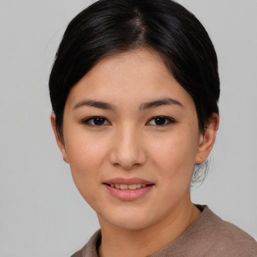 Joyful asian young-adult female with medium  black hair and brown eyes