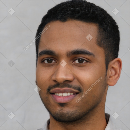 Joyful black young-adult male with short  black hair and brown eyes