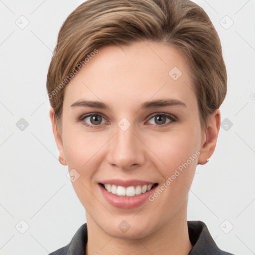 Joyful white young-adult female with short  brown hair and grey eyes