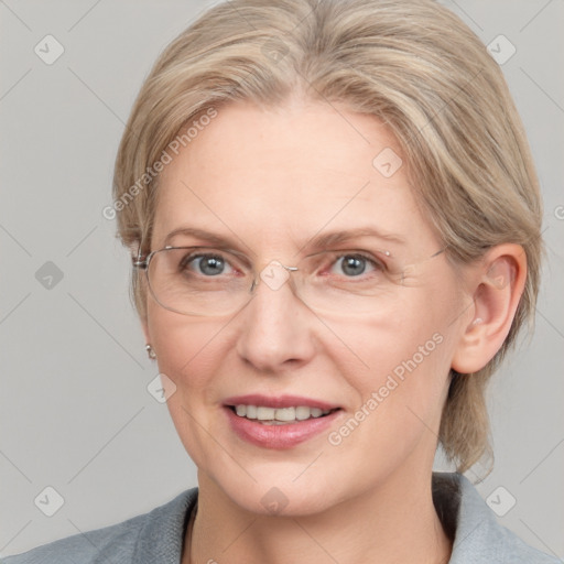 Joyful white adult female with medium  brown hair and blue eyes