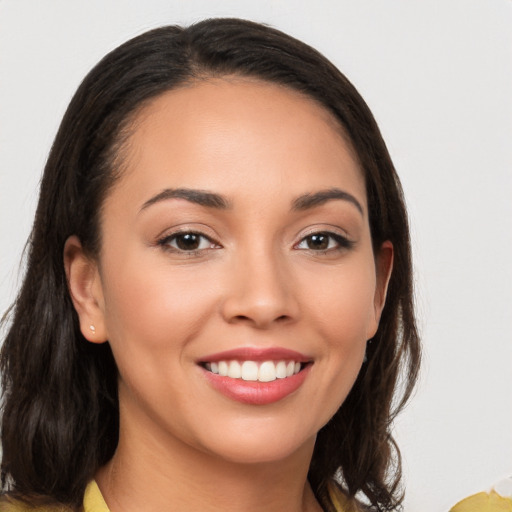 Joyful white young-adult female with long  brown hair and brown eyes