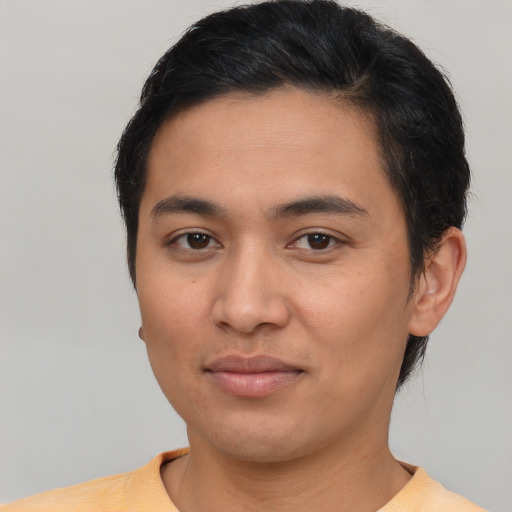 Joyful asian young-adult male with short  brown hair and brown eyes