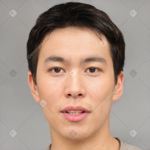 Joyful asian young-adult male with short  brown hair and brown eyes