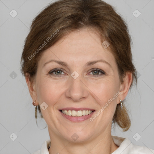 Joyful white adult female with medium  brown hair and grey eyes