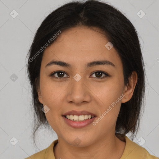 Joyful latino young-adult female with medium  brown hair and brown eyes