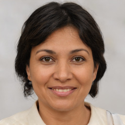 Joyful white adult female with medium  brown hair and brown eyes