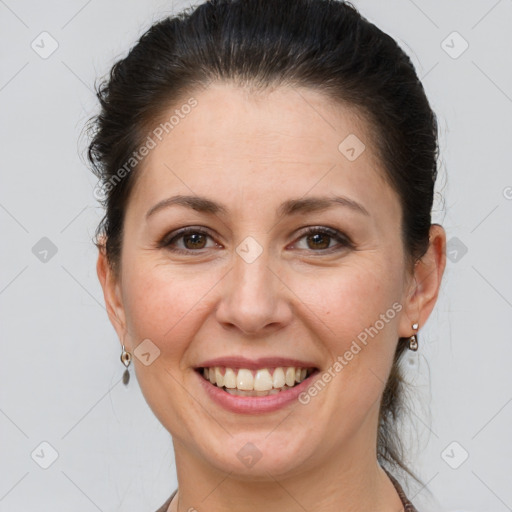 Joyful white adult female with medium  brown hair and brown eyes