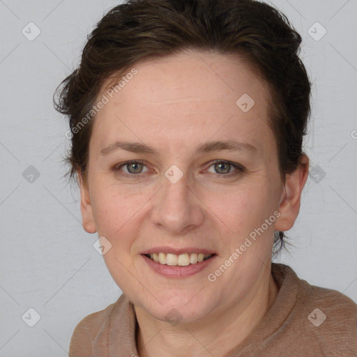 Joyful white adult female with medium  brown hair and blue eyes