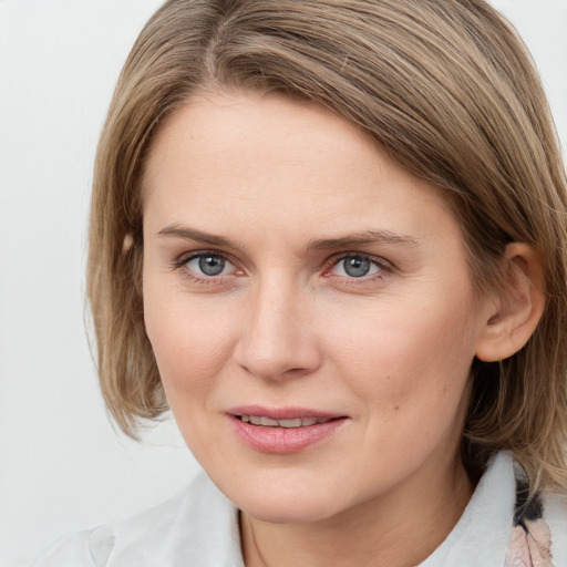 Joyful white young-adult female with medium  brown hair and blue eyes