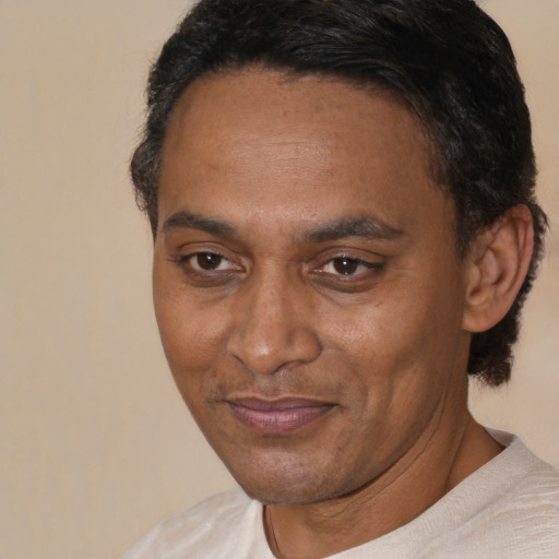 Joyful black adult male with short  brown hair and brown eyes