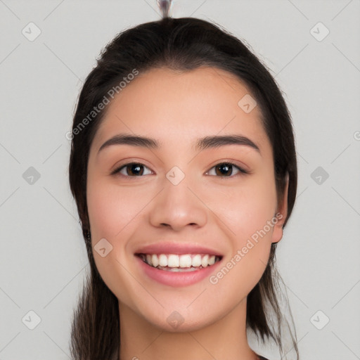 Joyful white young-adult female with long  brown hair and brown eyes