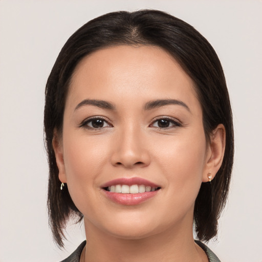 Joyful white young-adult female with medium  brown hair and brown eyes