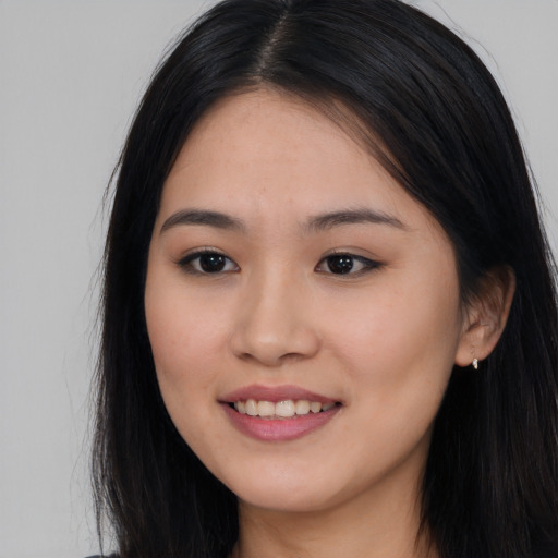 Joyful asian young-adult female with long  black hair and brown eyes