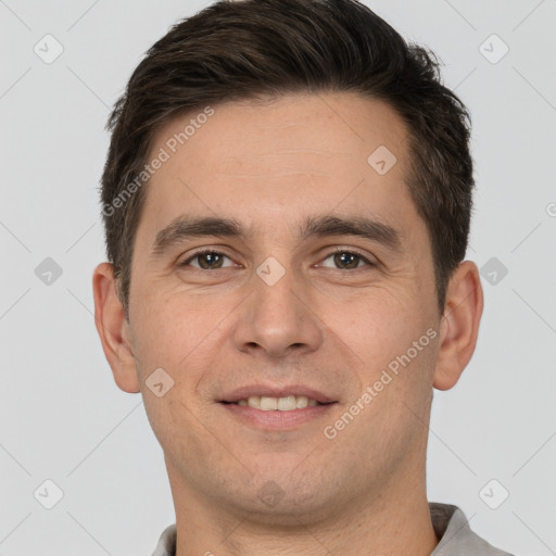 Joyful white young-adult male with short  brown hair and brown eyes