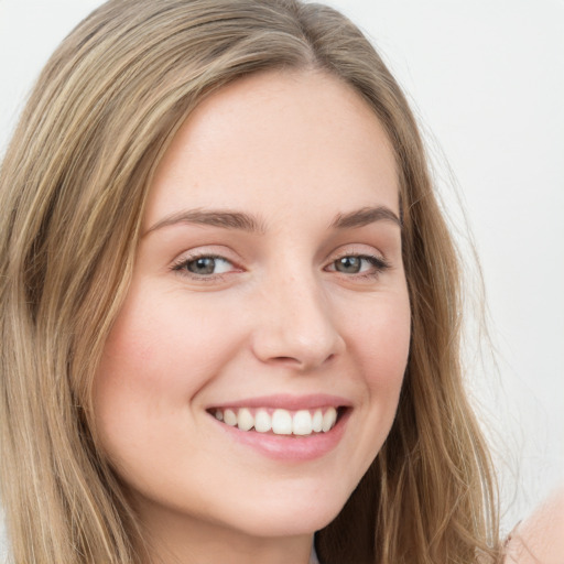 Joyful white young-adult female with long  brown hair and green eyes