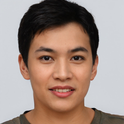 Joyful asian young-adult male with short  brown hair and brown eyes