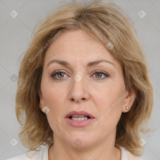 Joyful white adult female with medium  brown hair and blue eyes