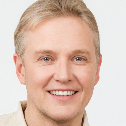 Joyful white adult male with short  brown hair and grey eyes