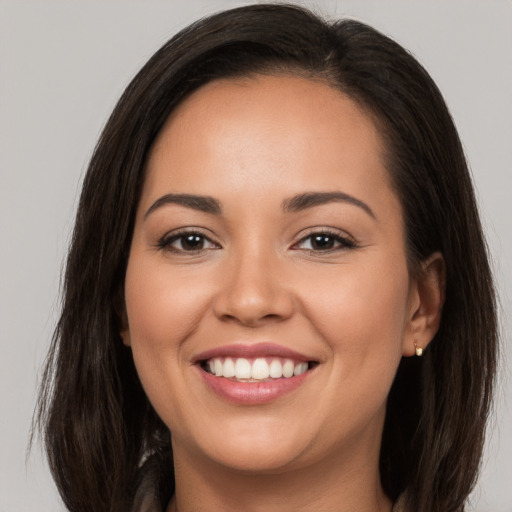 Joyful white young-adult female with long  brown hair and brown eyes