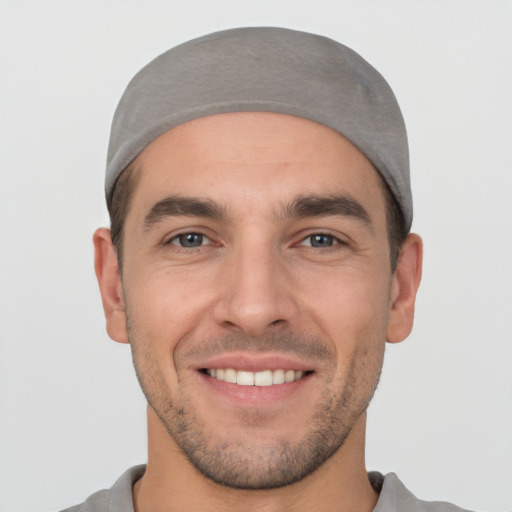 Joyful white young-adult male with short  black hair and brown eyes