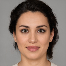 Joyful white young-adult female with medium  brown hair and brown eyes