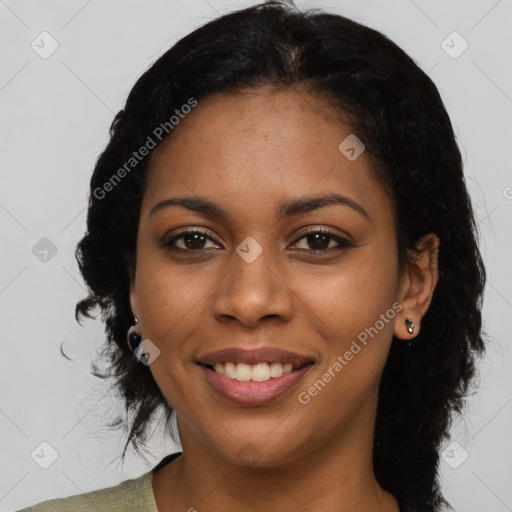 Joyful black young-adult female with long  black hair and brown eyes