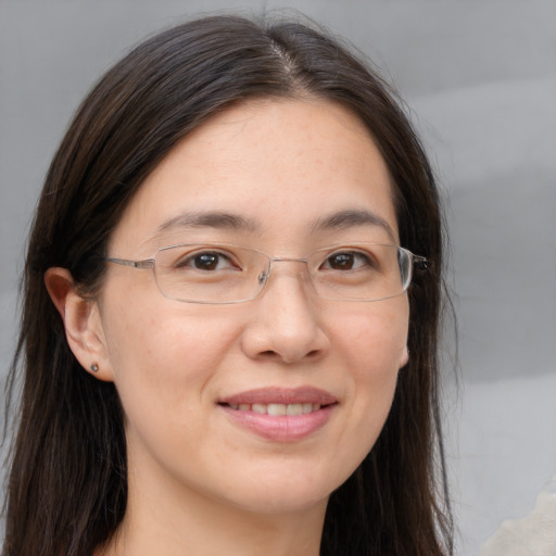 Joyful white adult female with long  brown hair and brown eyes