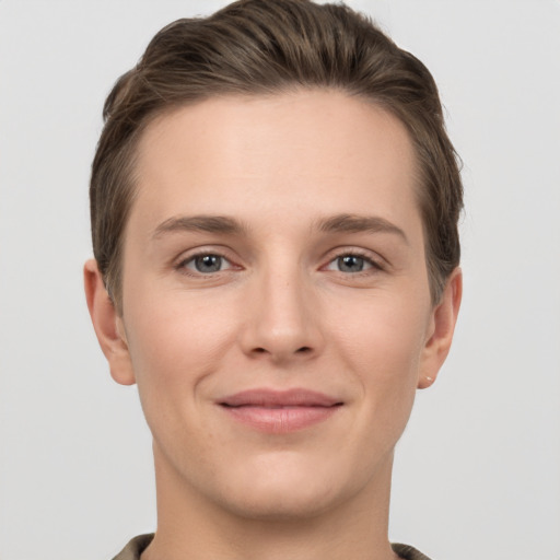 Joyful white young-adult female with short  brown hair and grey eyes