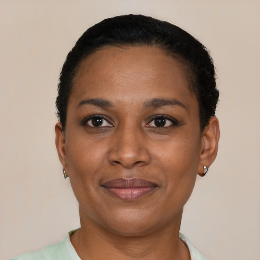 Joyful black adult female with short  black hair and brown eyes