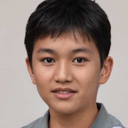 Joyful asian child male with short  brown hair and brown eyes