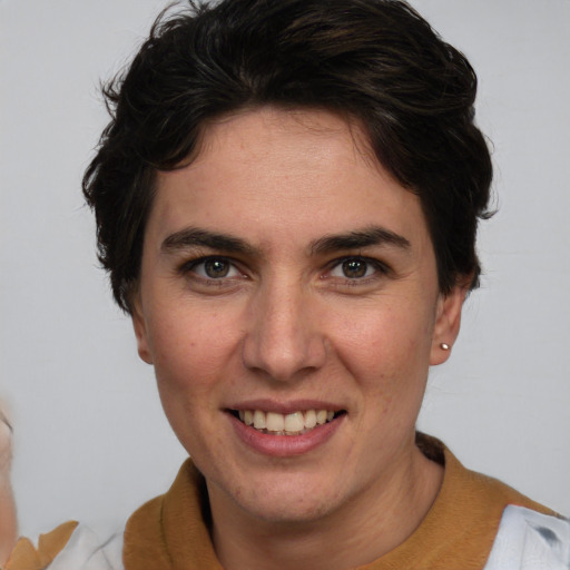 Joyful white young-adult female with short  brown hair and brown eyes