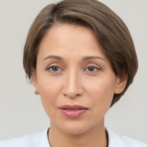 Joyful white adult female with short  brown hair and brown eyes