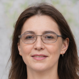 Joyful white adult female with long  brown hair and brown eyes