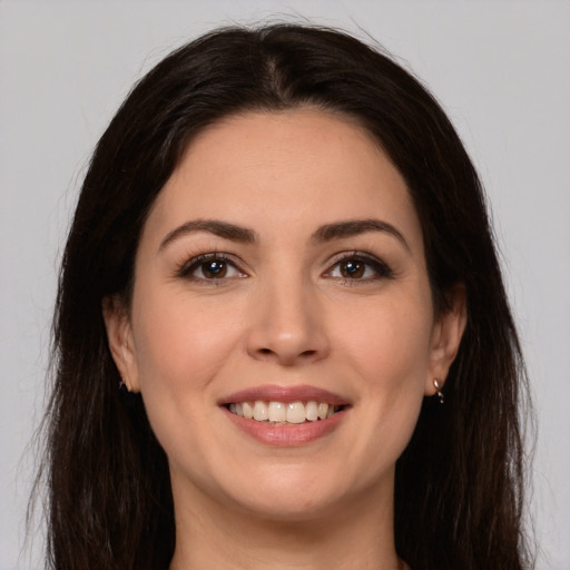 Joyful white young-adult female with long  brown hair and brown eyes