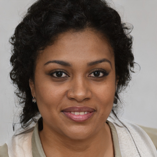 Joyful black young-adult female with medium  brown hair and brown eyes
