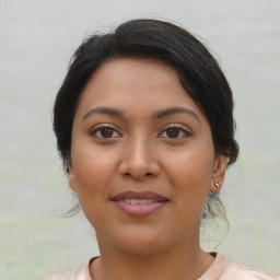 Joyful latino young-adult female with short  brown hair and brown eyes