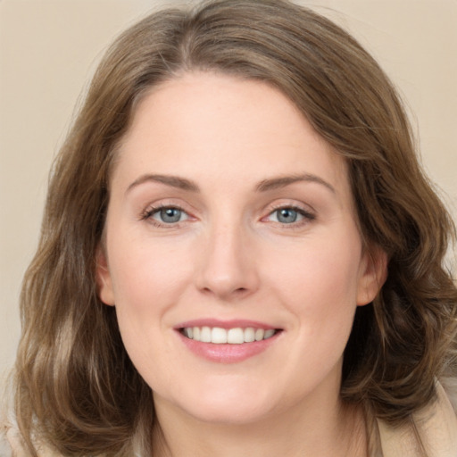 Joyful white young-adult female with medium  brown hair and green eyes