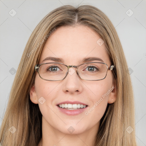 Joyful white young-adult female with long  brown hair and green eyes