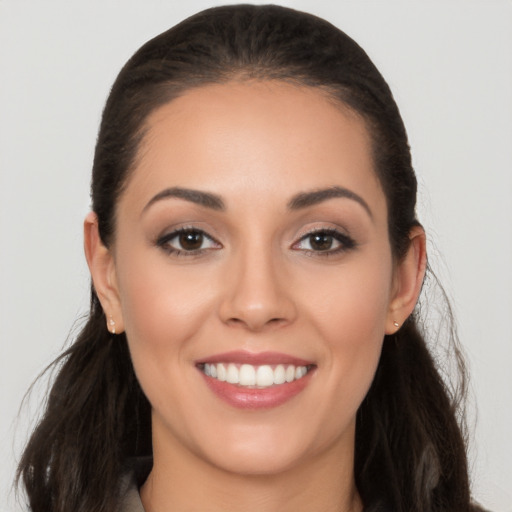 Joyful white young-adult female with long  brown hair and brown eyes