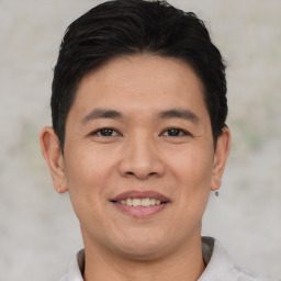 Joyful asian young-adult male with short  black hair and brown eyes