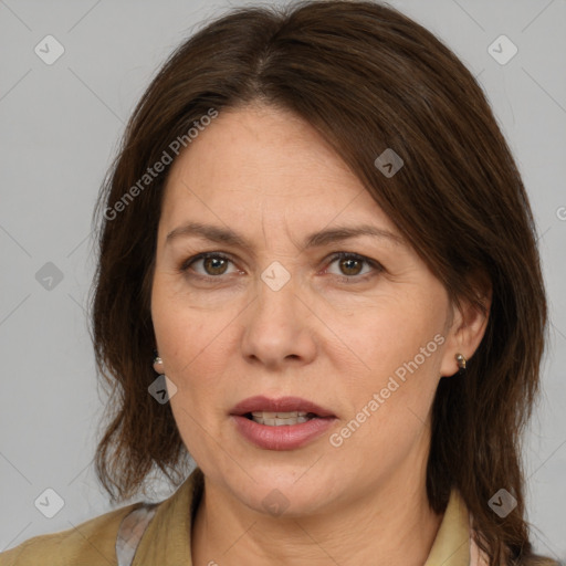 Joyful white adult female with medium  brown hair and brown eyes