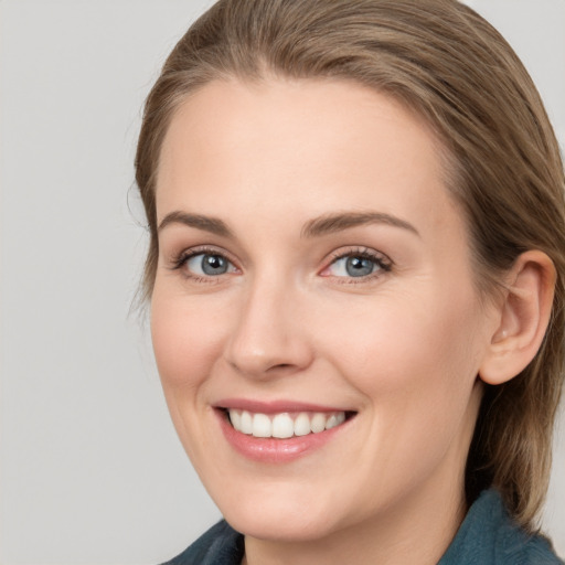 Joyful white young-adult female with medium  brown hair and blue eyes