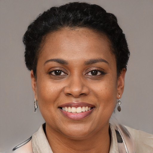 Joyful latino adult female with short  brown hair and brown eyes