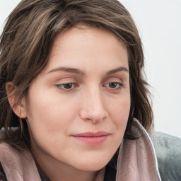 Joyful white young-adult female with long  brown hair and blue eyes