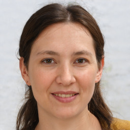 Joyful white adult female with medium  brown hair and brown eyes