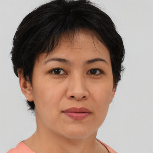 Joyful asian adult female with short  brown hair and brown eyes