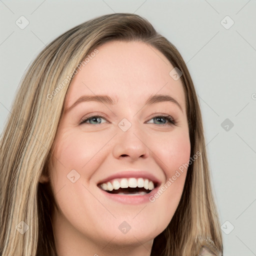 Joyful white young-adult female with long  brown hair and blue eyes