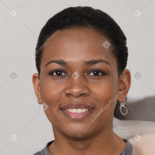 Joyful black young-adult female with short  black hair and brown eyes