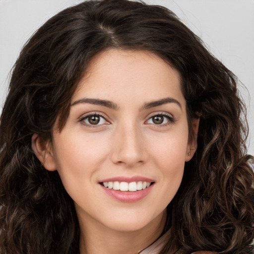 Joyful white young-adult female with long  brown hair and brown eyes