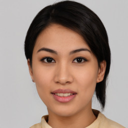 Joyful asian young-adult female with medium  black hair and brown eyes